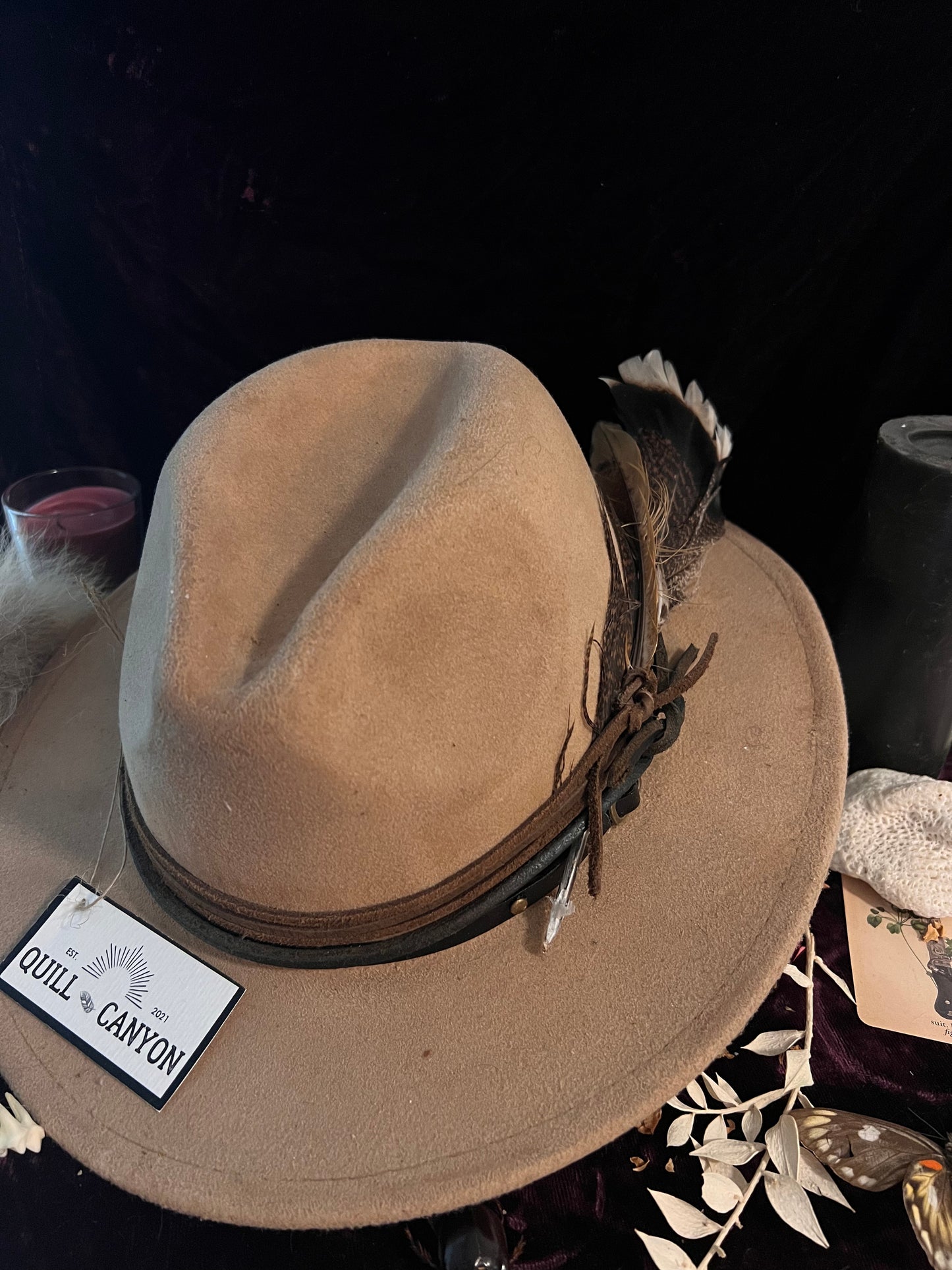 Burned light leather hat with leather wraps and feathers Quill Canyon